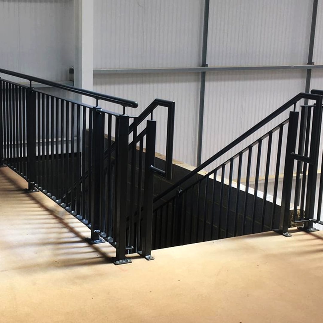 Staircase with black steelwork, handrail up to a mezzanine floor - ATC Installations