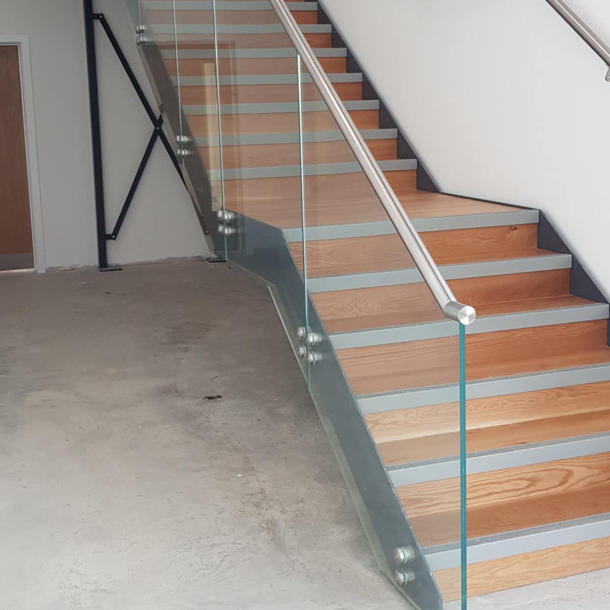 Stainless steel with oak tread and glass infill system building staircase and Edge Protection - ATC Installations