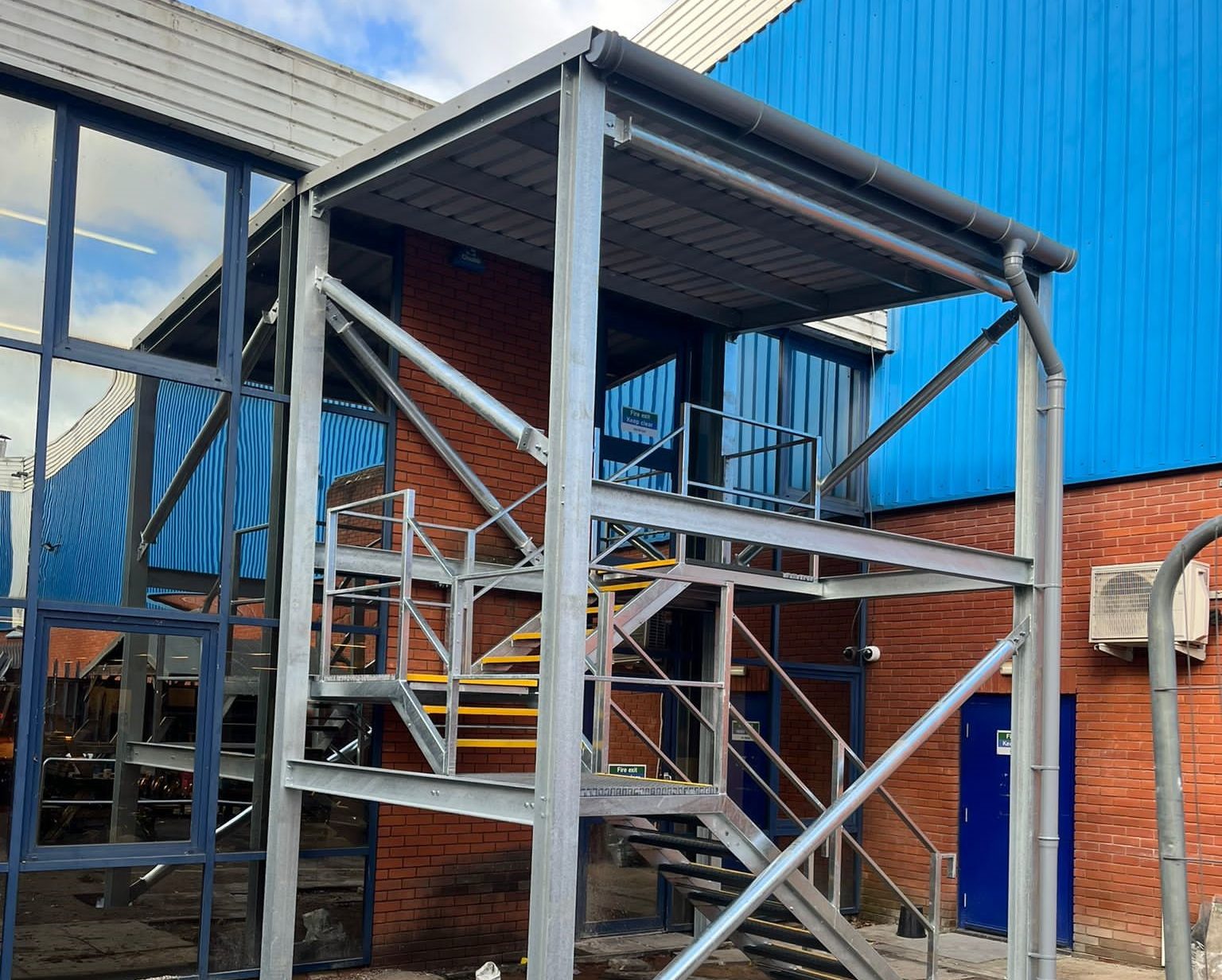 Exterior fire escape staircase with cover - ATC Installations